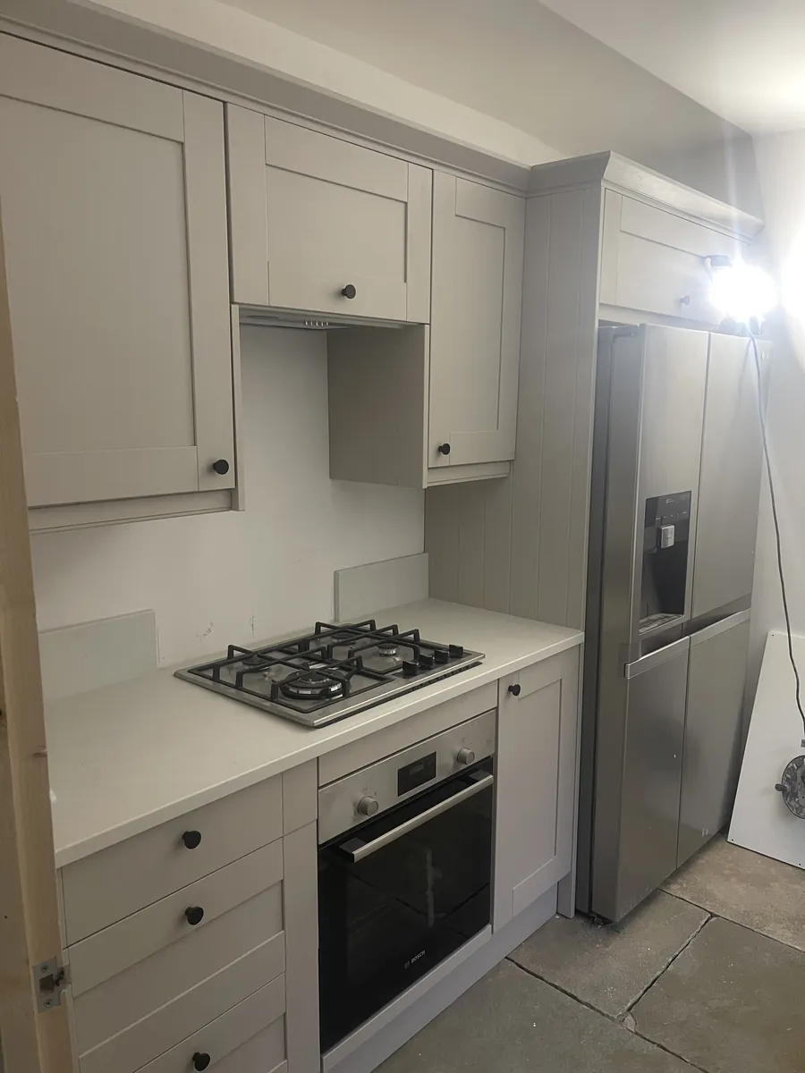 Greige shaker kitchen part-fitted with gas hob and built-under oven in place